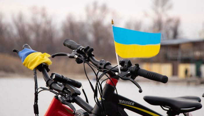 Ukraine Dnepr 29.03.2022 - Yellow-blue flag of Ukraine on a bicycle in a city in Ukraine, a protest action, stop the war in Ukraine, a patriot of his country